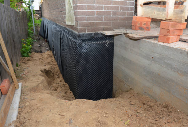 Happy homeowners after waterproofing job in Covert